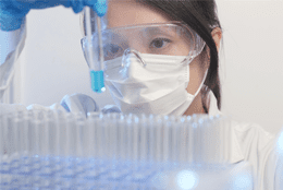 Scientist holding a vial