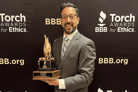 V2V President Daniel Rehal holds the 2024 BBB Torch Award for Ethics and Excellence